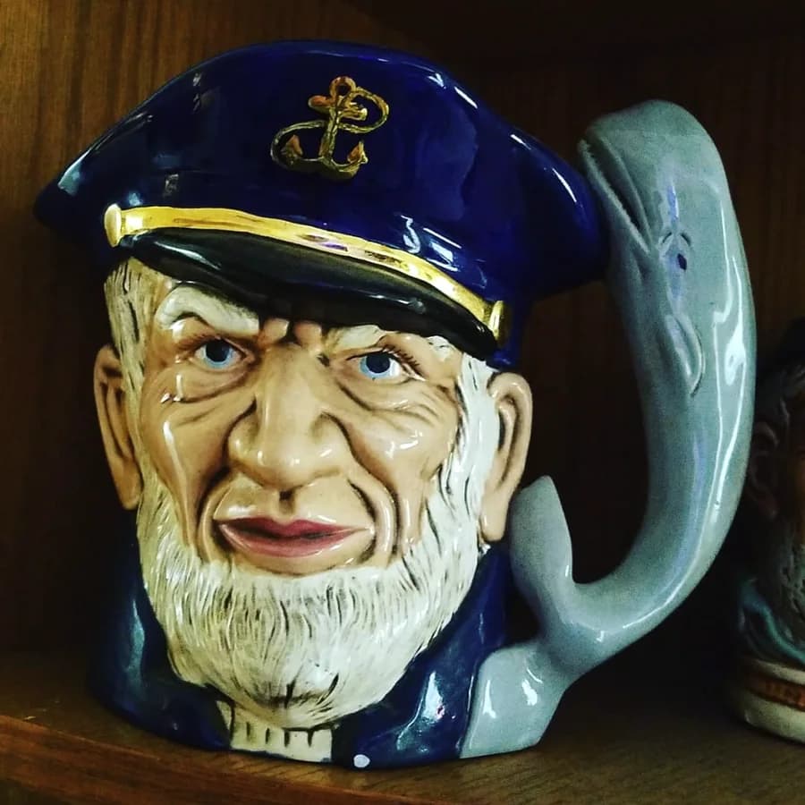 A sea captain character jug with a whale handle